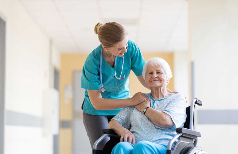A nurse helping an older adult check their blood pressure in a comfortable residential living area.